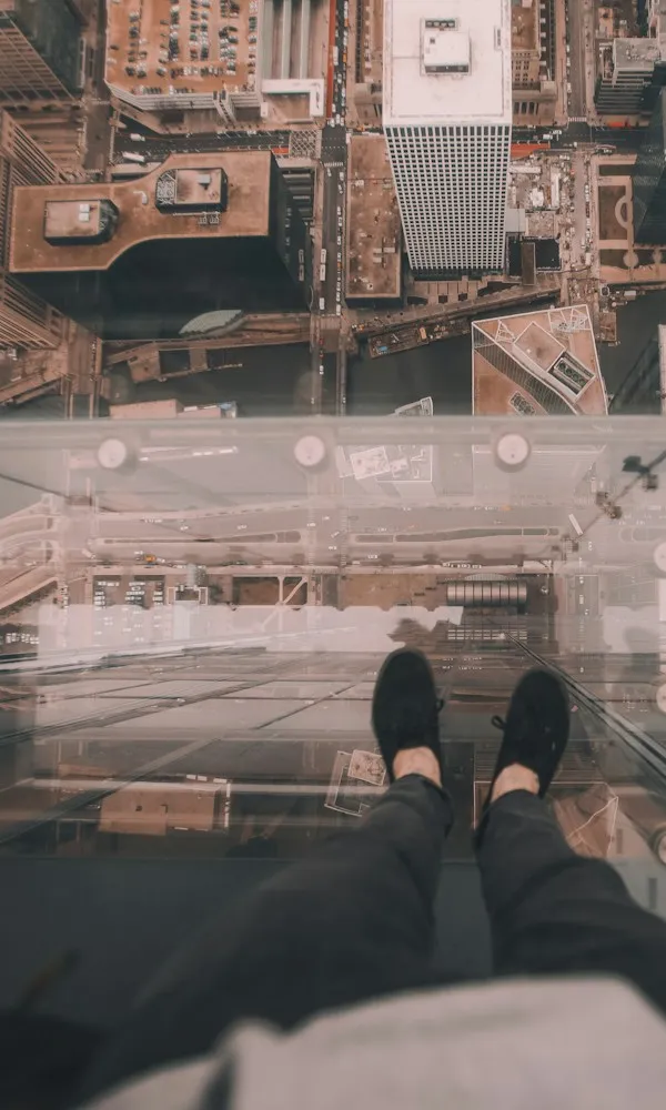 Looking straight down from a glass platform high above the city — phobia therapy in Los Angeles