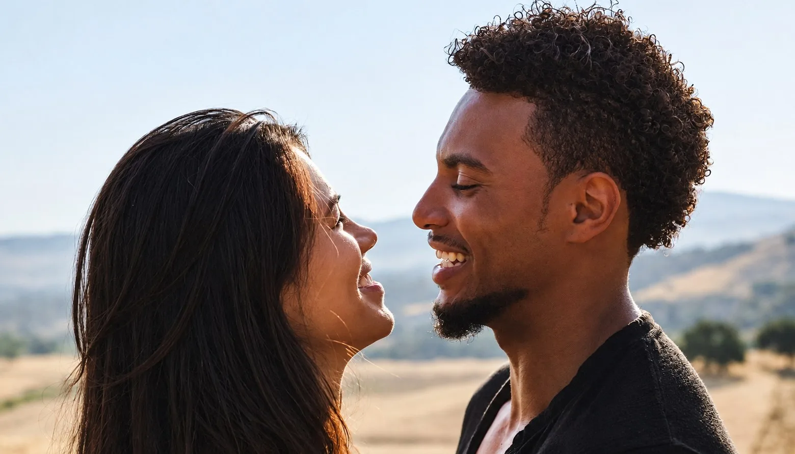 A couple smiling face to face in warm evening light — couples therapy in Los Angeles
