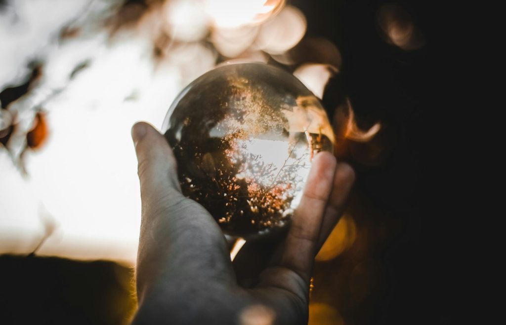 Close-up of hands gently holding a glowing light, symbolizing self-compassion and healing through Internal Family Systems therapy.