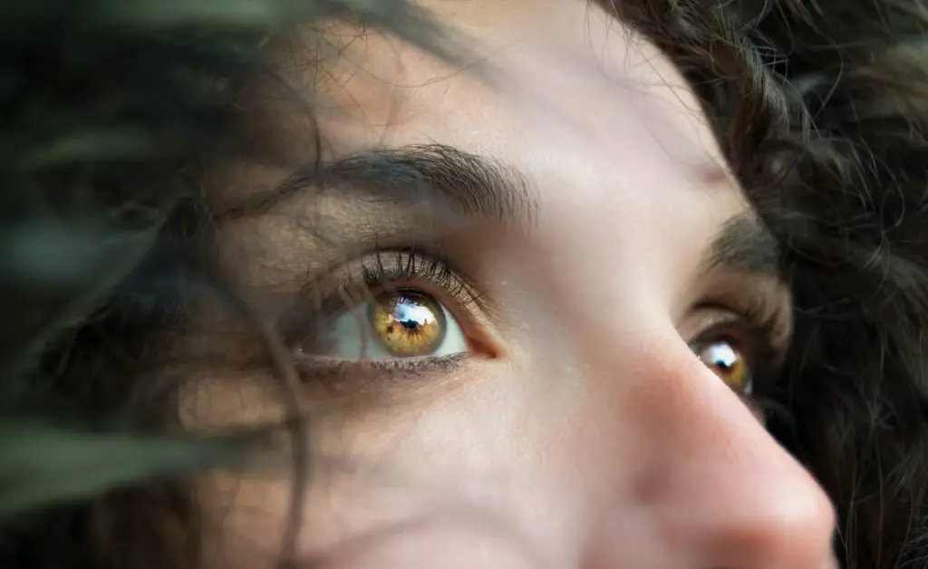 Close-up portrait of a person in deep reflection, symbolizing self-discovery and resilience.